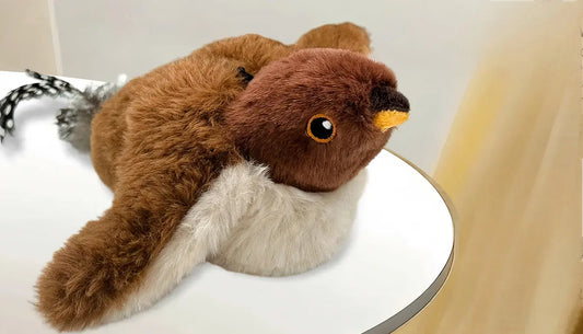 Brown and white plush flying bird cat toy with detailed beak and eyes on a white surface