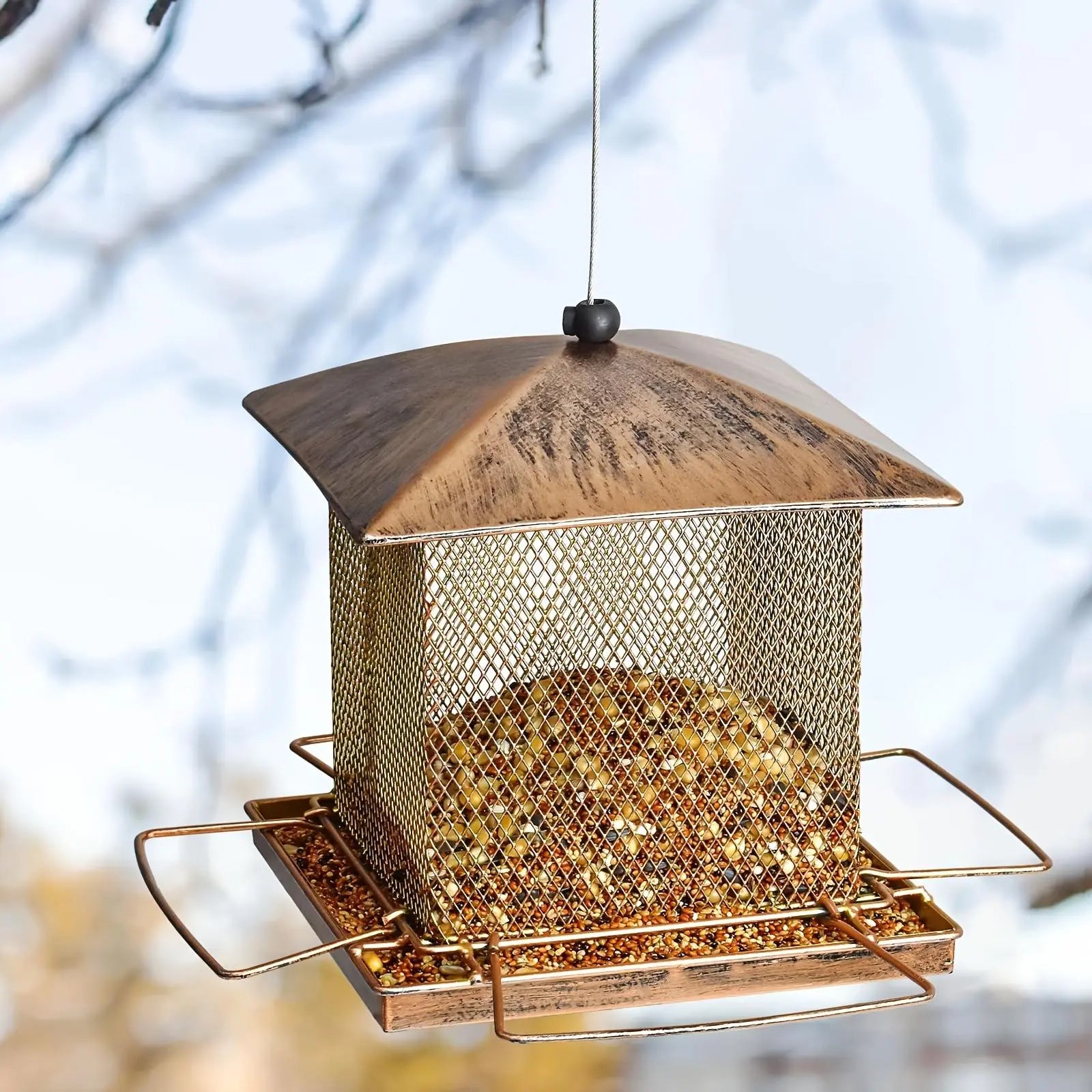 FelRelWel squirrel proof bird feeder with metal mesh design and copper roof hanging outdoors